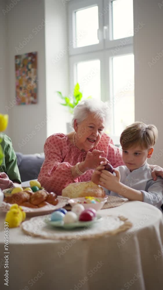 Grandmother with little kids decorating easter eggs at home. Tradition of painting eggs with brush and easter egg dye. Grandmother with little kids decorating easter eggs at home. Tradition of painting eggs with brush and easter egg dye.