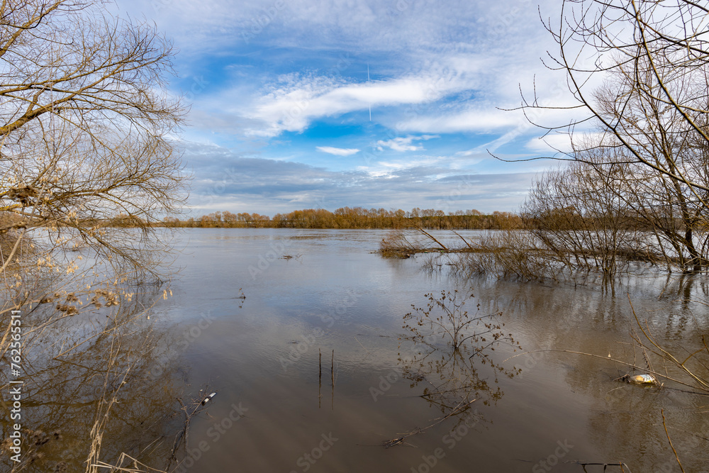 early spring flood, high water in the countryside, river overflowing its banks, trees in the water, flooded banks, environmental pollution, ecology early spring flood, high water in the countryside, river overflowing its banks, trees in the water, flooded banks, environmental pollution, ecology