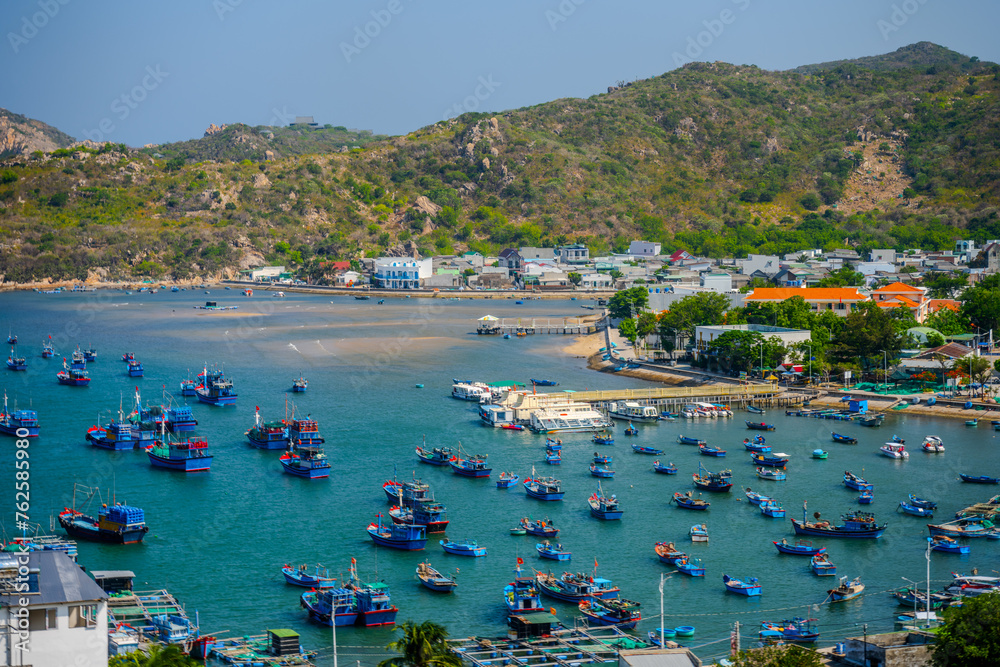Picturesque Fishing Harbor in Ninh Thuan, Vietnam with Coastal Town Backdrop