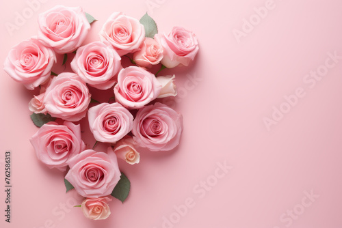 Bouquet of pink roses arranged in heart shape on pink background. Roses are of various sizes and are placed in way that creates sense of harmony and balance. Scene is one of love