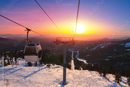 Landscape ski lift resort with snowy forest on mountain in winter sunlight, Sheregesh, Kemerovo region Russia