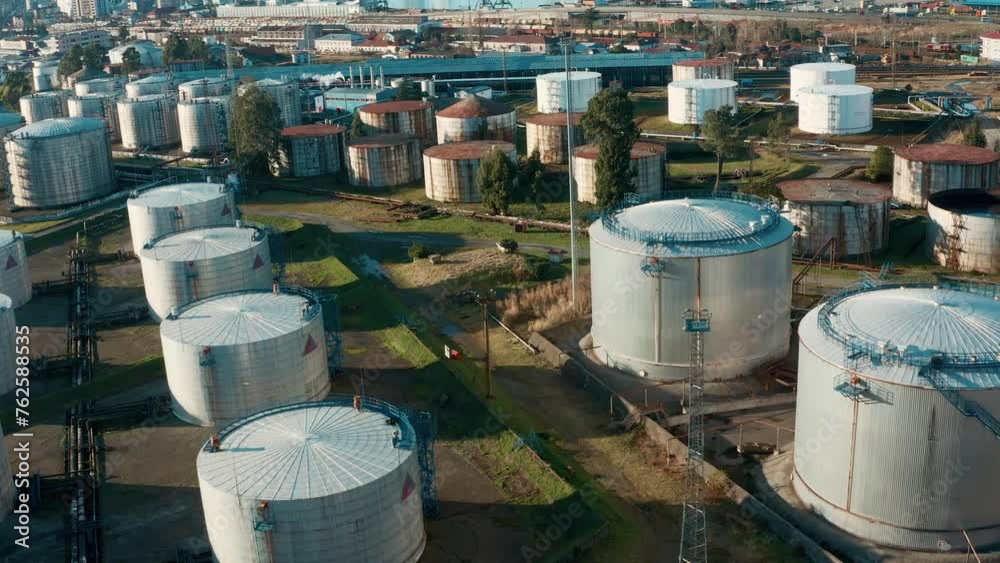 Aerial view of oil tanks at oil refinery. Gas and oil steel storage tanks. Petrol industrial plant Aerial view of oil tanks at oil refinery. Gas and oil steel storage tanks. Petrol industrial plant