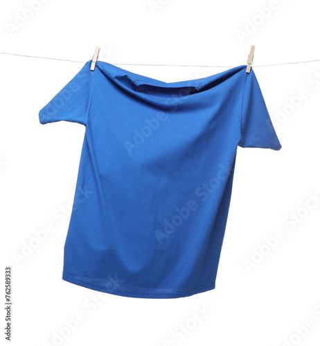 One blue t-shirt drying on washing line isolated on white