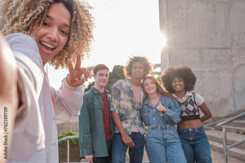 Group of diverse young people taking a selfie together outdoors. Concept: friends, bond