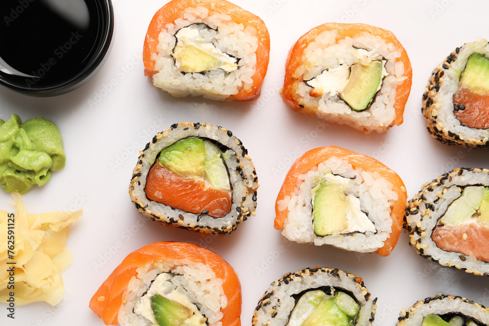 Delicious sushi rolls on white background, flat lay Delicious sushi rolls on white background, flat lay