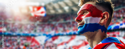 Happy Croatian male supporter with face painted in Croatian flag consists of A horizontal tricolour of red, white, and blue, Croatian male fan at a sports event such as football or rugby match