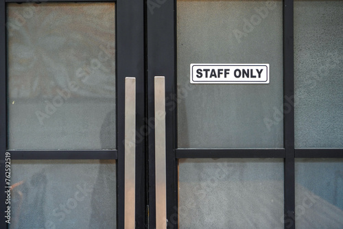Warning sign on front door with message for staff only