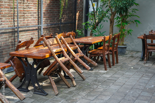simple minimalist wooden tables and chairs for sitting and drinking coffee in a coffee shop with a natural atmosphere