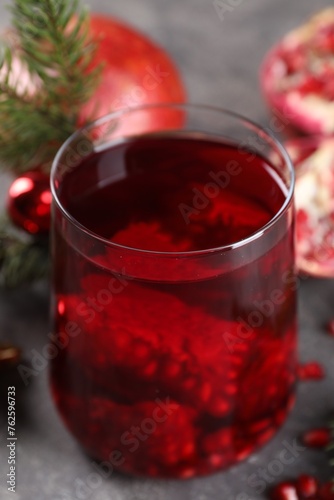 Aromatic Sangria cocktail in glass on grey table, closeup. Christmas drink