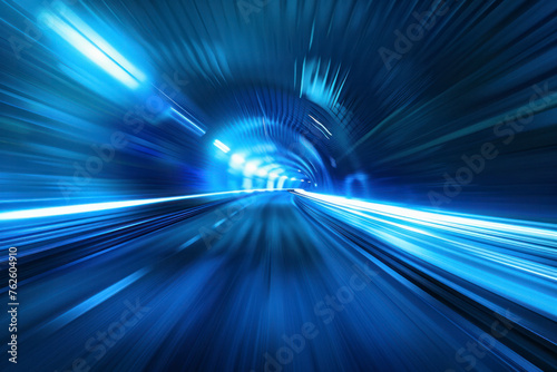 Blue Abstract blurred speed motion in urban highway road tunnel, moving toward the light.