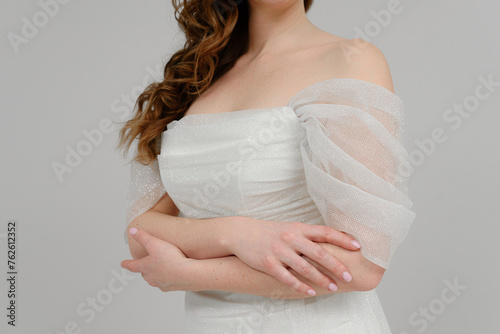 young bride in wedding dress, hands on wrist, cropped, unrecognizable, no face