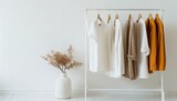 female autumn clothes on hangers in white room