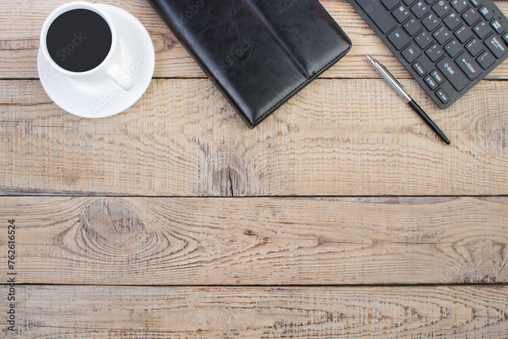 Wooden office table with computer, pen and a cup of coffee, lot of things. Top view with copy space. Wooden office table with computer, pen and a cup of coffee, lot of things. Top view with copy space.