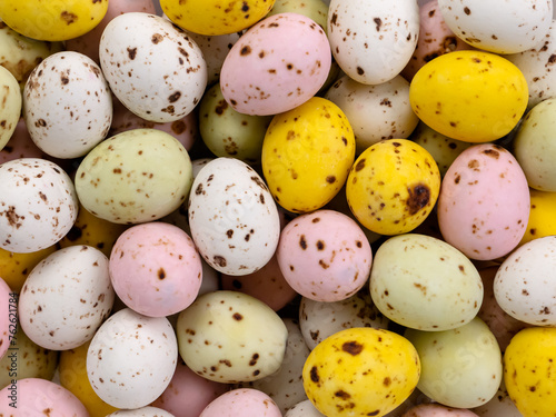 Decor in the form of colorful quail eggs. chocolate eggs for decoration. background