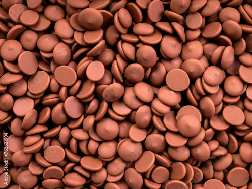 dark chocolate in the form of callets, drops. background photo