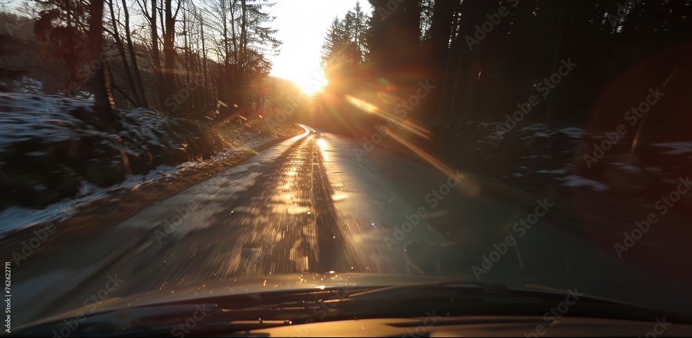 a car driving down a road with trees in the background - obrazy, fototapety, plakaty 