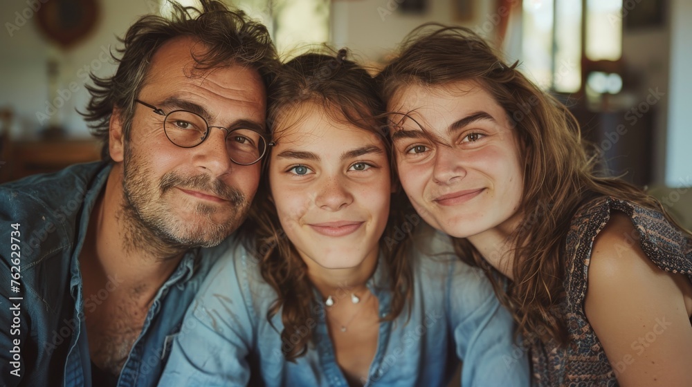 A family of three and their friends gather together, smiling, and posing for a photograph in a park. They are standing close to each other, looking at the camera with cheerful expressions. A family of three and their friends gather together, smiling, and posing for a photograph in a park. They are standing close to each other, looking at the camera with cheerful expressions.