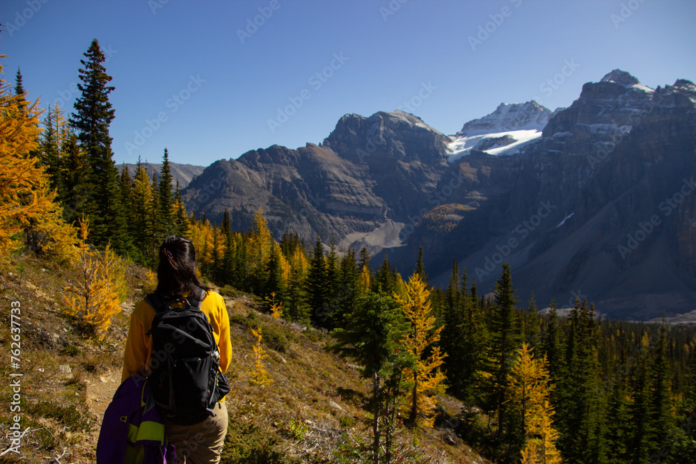 Woman hiker walking through the Rocky Mountains of Canada.