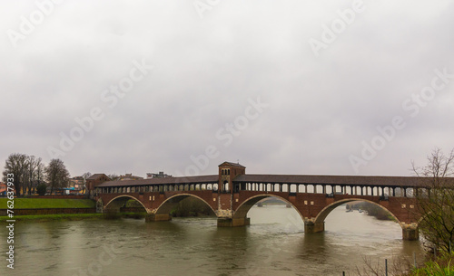 Ponte Coperto (Covered bridge) over river Ticino in Pavia, Italy on a rainy day © Faina Gurevich