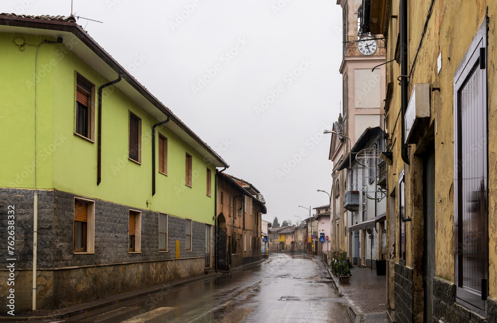 Empty street with historic buildings in a small Italian village on a rainy day