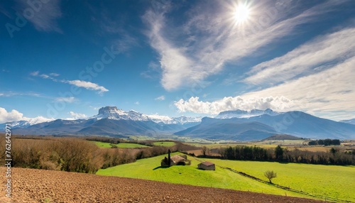 countryside landscape in the gers department in france with the pyrenees mountains in the background