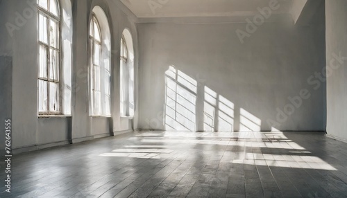 empty white room with shadows of windows and light