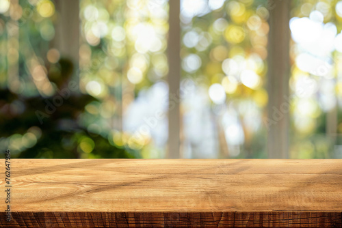 Wooden tabletop with bokeh light effect through windows in a natural sunlight background. High quality photo