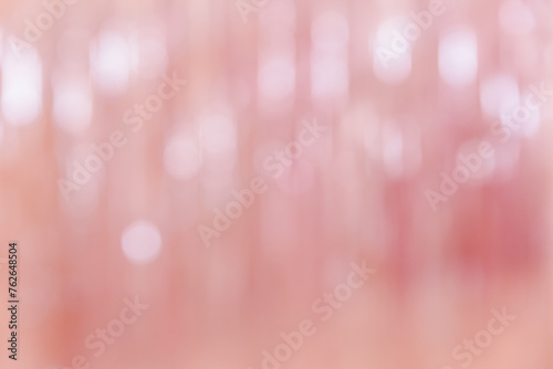 Abstract pink defocused background with light bokeh. Festive, holiday or anniversary party concept. Decorative wallpaper, feminine style