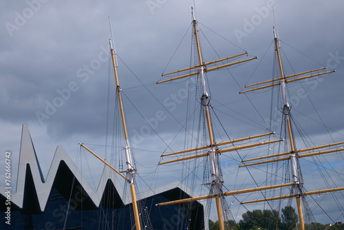 The masts of an old sailing ship moored to the pier. The Tall Ship at Glasgow Harbour