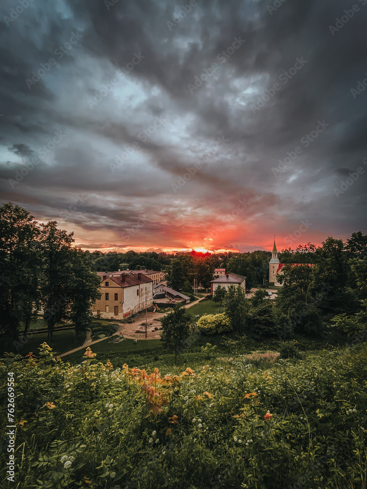 Naklejka premium sunset after rain over city with dark dramatic clouds