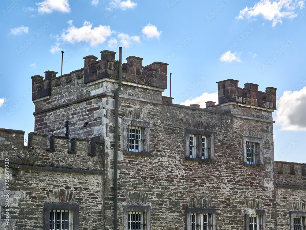 Old celtic castle tower and a house. Ancient Irish architecture background