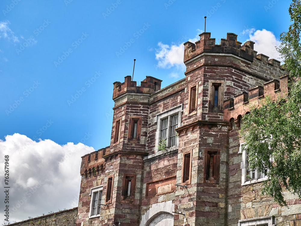 Old celtic castle tower and a house. Ancient Irish architecture background - obrazy, fototapety, plakaty 