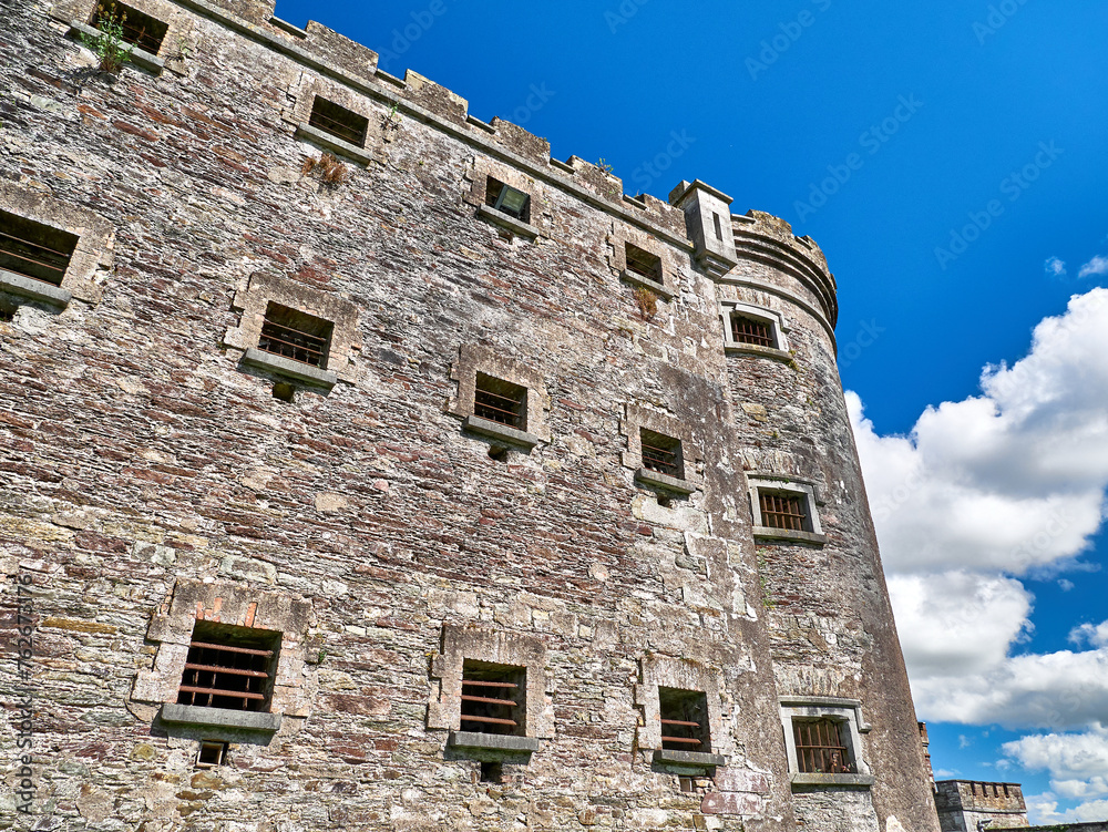 Old celtic castle tower and a house. Ancient Irish architecture background Old celtic castle tower and a house. Ancient Irish architecture background