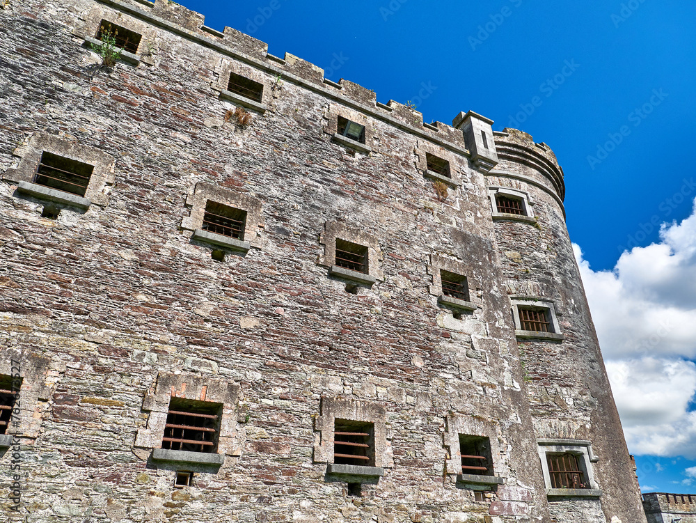 Old celtic castle tower and a house. Ancient Irish architecture background Old celtic castle tower and a house. Ancient Irish architecture background