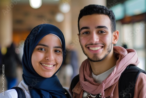 Smiling middle eastern students looking at the camera male and female.   © Adriana