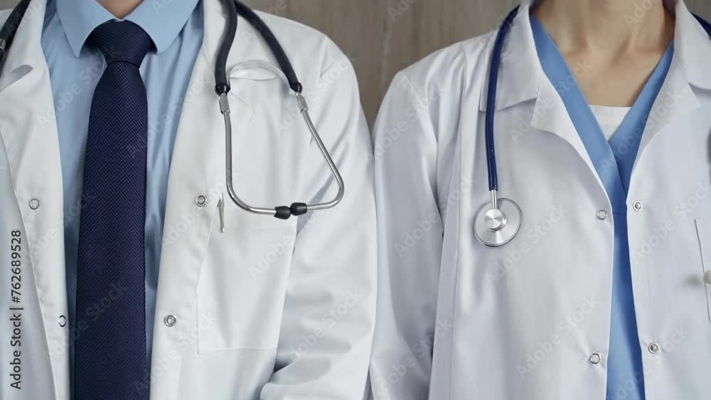 Professional healthcare team in uniform. Two doctors with stethoscopes are standing straight. Medicine concept Professional healthcare team in uniform. Two doctors with stethoscopes are standing straight. Medicine concept