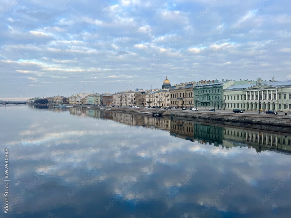 Fototapeta premium City river reflection, clouds and buildings reflection on the river surface, mirror