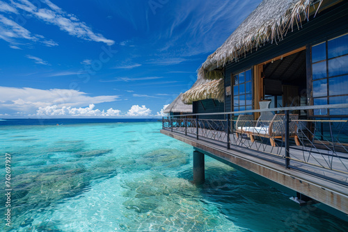 A luxurious overwater bungalow with an abstract design  offering unobstructed views of the turquoise sea