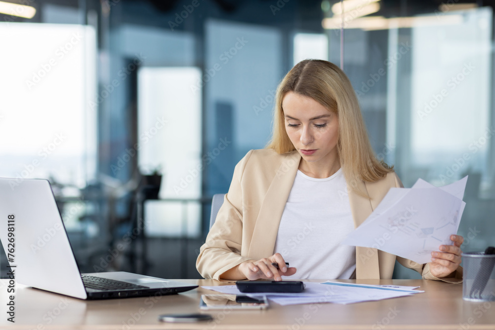 Professional businesswoman working with documents at office desk Professional businesswoman working with documents at office desk