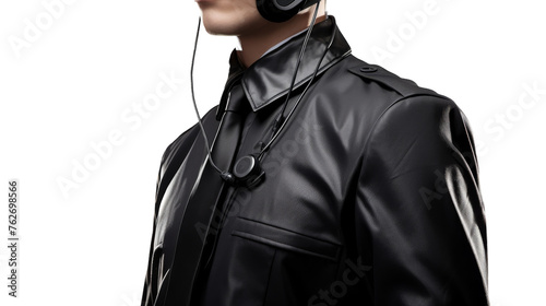A man in a leather jacket listens to music through headphones