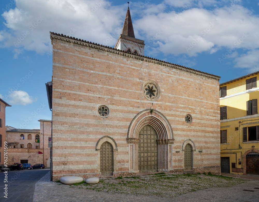 Medieval collegiate church of San Salvatore in Foligno, Umbria , Italy , view of banded pink stone facade - obrazy, fototapety, plakaty 