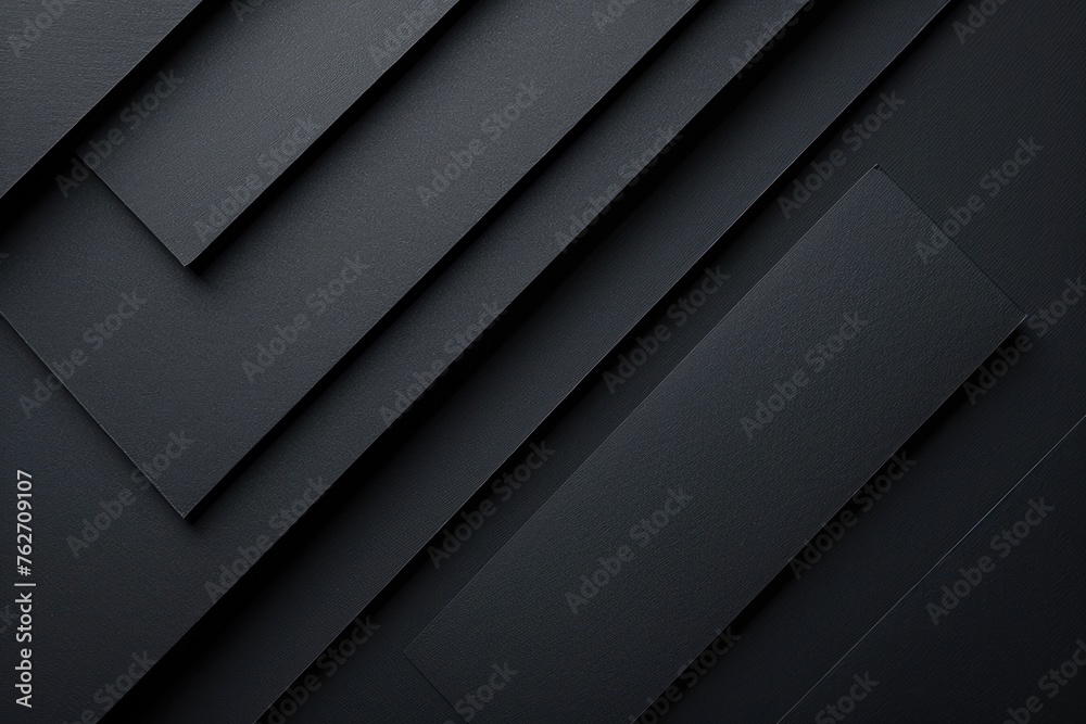 A black and white photo of a stack of black paper. Dark graphite grey abstract textured geometric - obrazy, fototapety, plakaty 