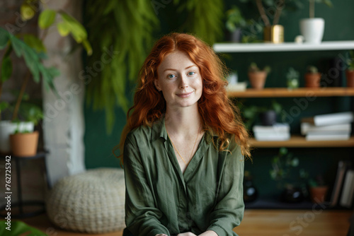 Happy serene calm young business woman employee with red hair