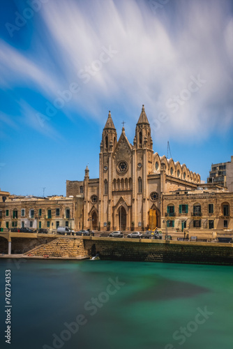 St Julian's, Malta - June 2023: Knisja tal-Karmnu,Parish Church of Our Lady of Mount Carmel located in Balluta Bay. Long exposure picture