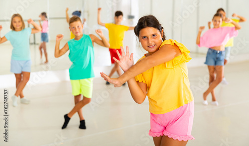 Children exercising modern dance moves together during their group classes.