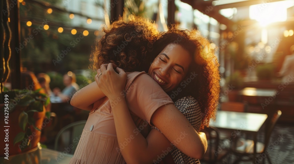 beautiful women giving each other a greeting hug in a restaurant or cafe during the day and very happy in high resolution and high quality. concept friends, biodiversity, multicultural
