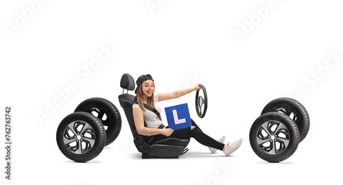 Happy girl holding an L-sign in a car seat photo