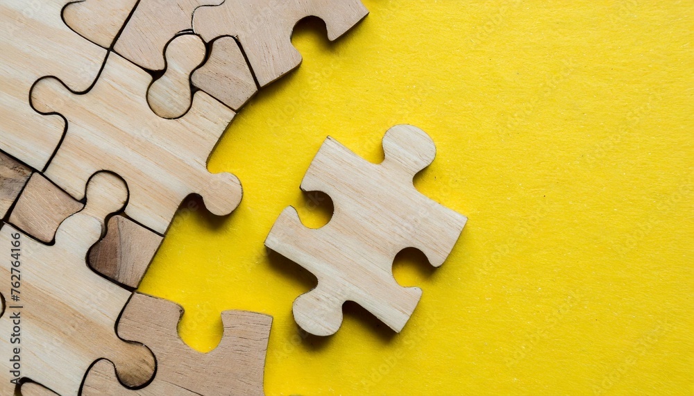 Fototapeta premium wooden pieces jigsaw puzzle on yellow background