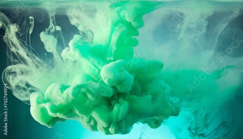 abstract blue and green paint splash isolated light green paint dissolves in water on a background like a cloud or smoke background