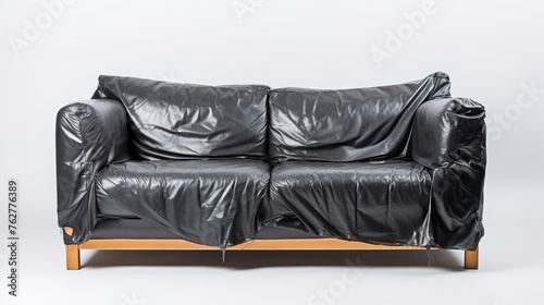 broken black leather sofa with wood leg on white background, broke and fix concept.    © Tumelo